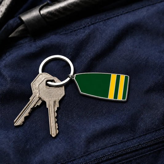 Custom rowing oar keyring attached to keys on a navy rowing bag